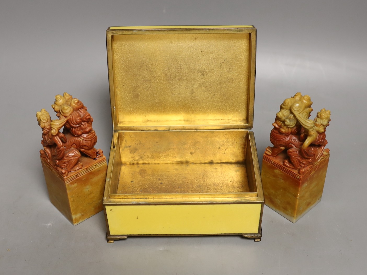 Two soapstone lion dogs and yellow enamelled box